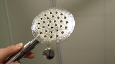 Limestone-covered-showerhead-in-hotelroom-check