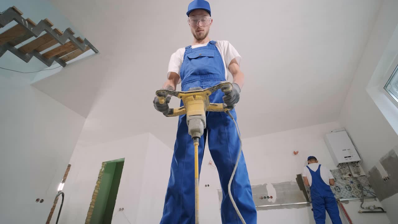 Installing ceramic floor tiles - measuring and cutting the pieces. Construction, renovation, repair apartment. Cuts tile. Tile cutting