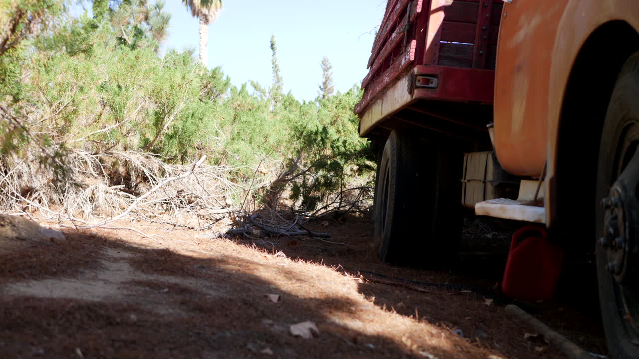 햇빛에 유리 헤드라이트와 그릴이 있는 중미의 오래된 녹슨 빈티지 트럭 펜더 전면의 극적인 영화적 풀백 샷