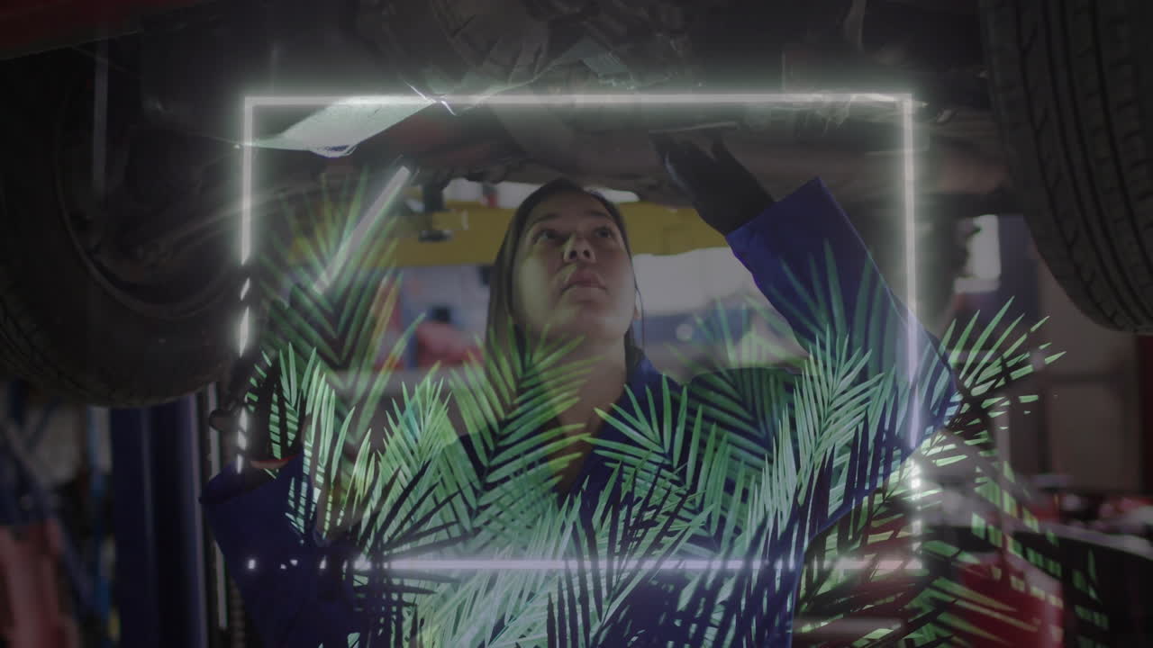 female mechanic checking undercarriage with flashlight in shop, with neon and palm leaf overlays