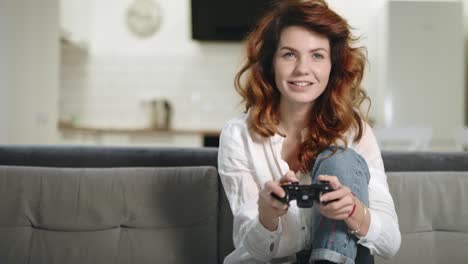 playful woman trying to win video game at open kitchen.