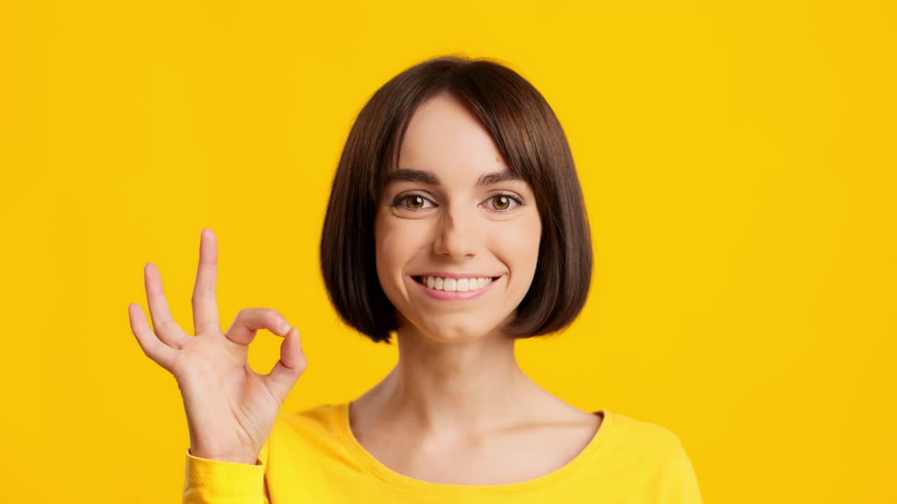 Woman Smiling and Giving an Ok Sign