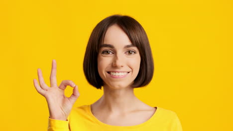 woman smiling and giving an ok sign