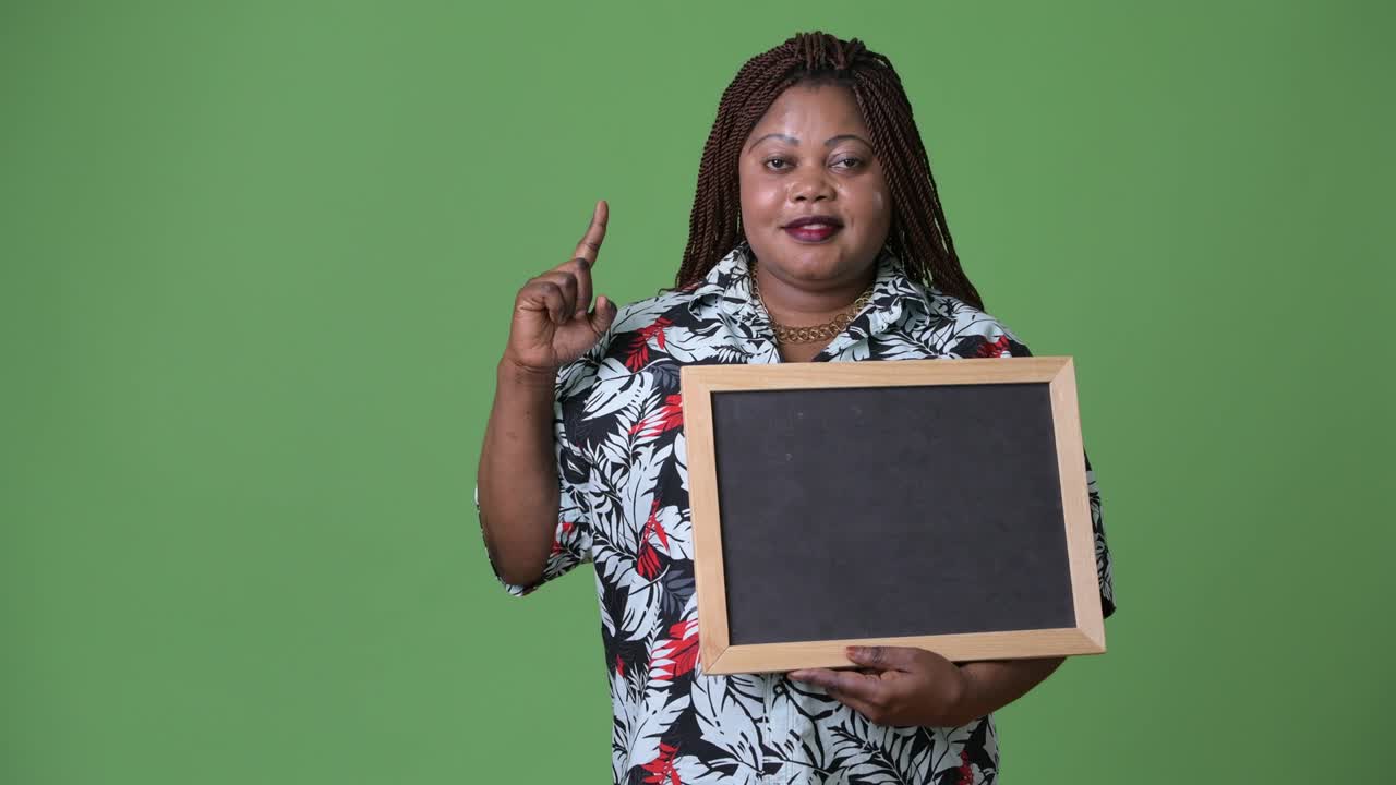 Overweight beautiful African woman against green background
