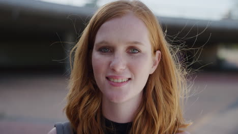 close up portrait beautiful young red head woman smiling happy running hand through hair looking confident enjoying lifestyle