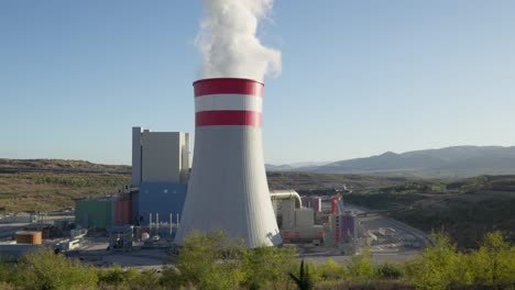 Coal-fired-power-station-plant-cooling-towers-emitting-Smoke-Steam-sunny-day