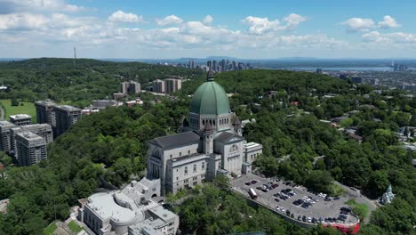 4k cinematic urban landscape timelapse of a drone flying around the observatory saint joseph in montreal, quebec on a sunny day, behind mount royal capturing a beautiful panoramic view