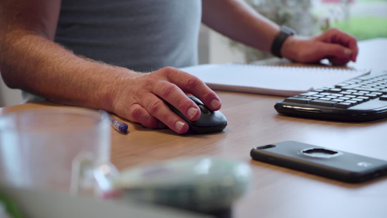 Male office worker using mouse, home working, remote working
