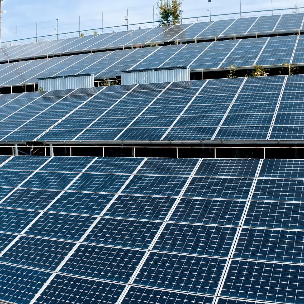 Photovoltaic infrared solar panels receiving photons from sun. Green clean energy on solar farm. Renewable energy. Solar panels on the ground at angle