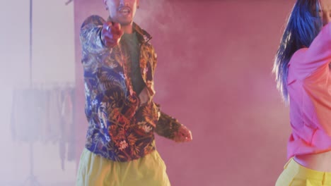 portrait of happy diverse male and female dancers dancing in dance studio, slow motion