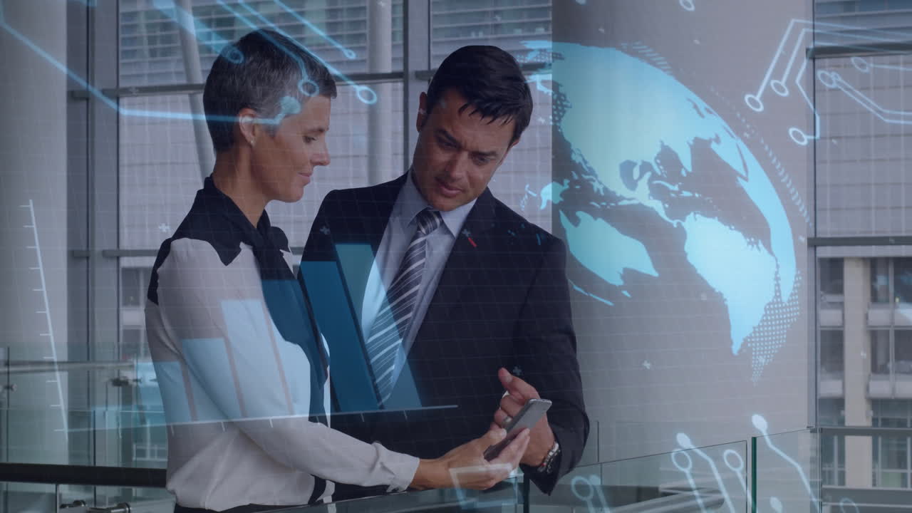 Business professionals examining smartphone in office atrium, showing bar charts and map overlays