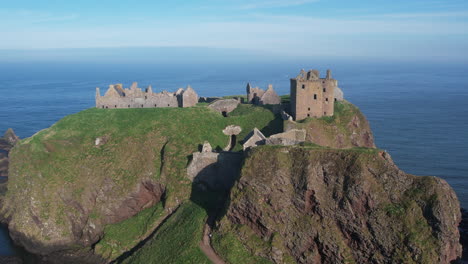 birds eye view of the huge rock on the scottish shore where the ruins of the once mighty dunnottar castle rise