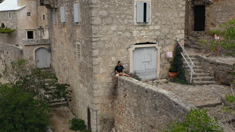 tourists at hermitage blaca in brac island, croatia - aerial pullback