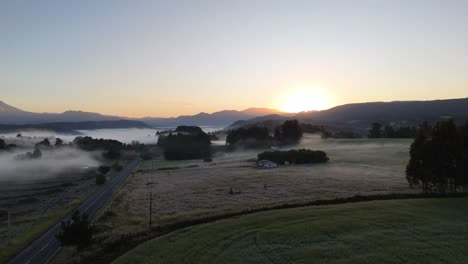 Early-in-the-morning-the-sun-rises-over-the-mountain-peaks-onto-a-dew-covered-landscape