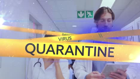 Words-Danger,-Virus,-Quarantine-written-on-yellow-tape-over-doctors-working.-Covid-19-spreading