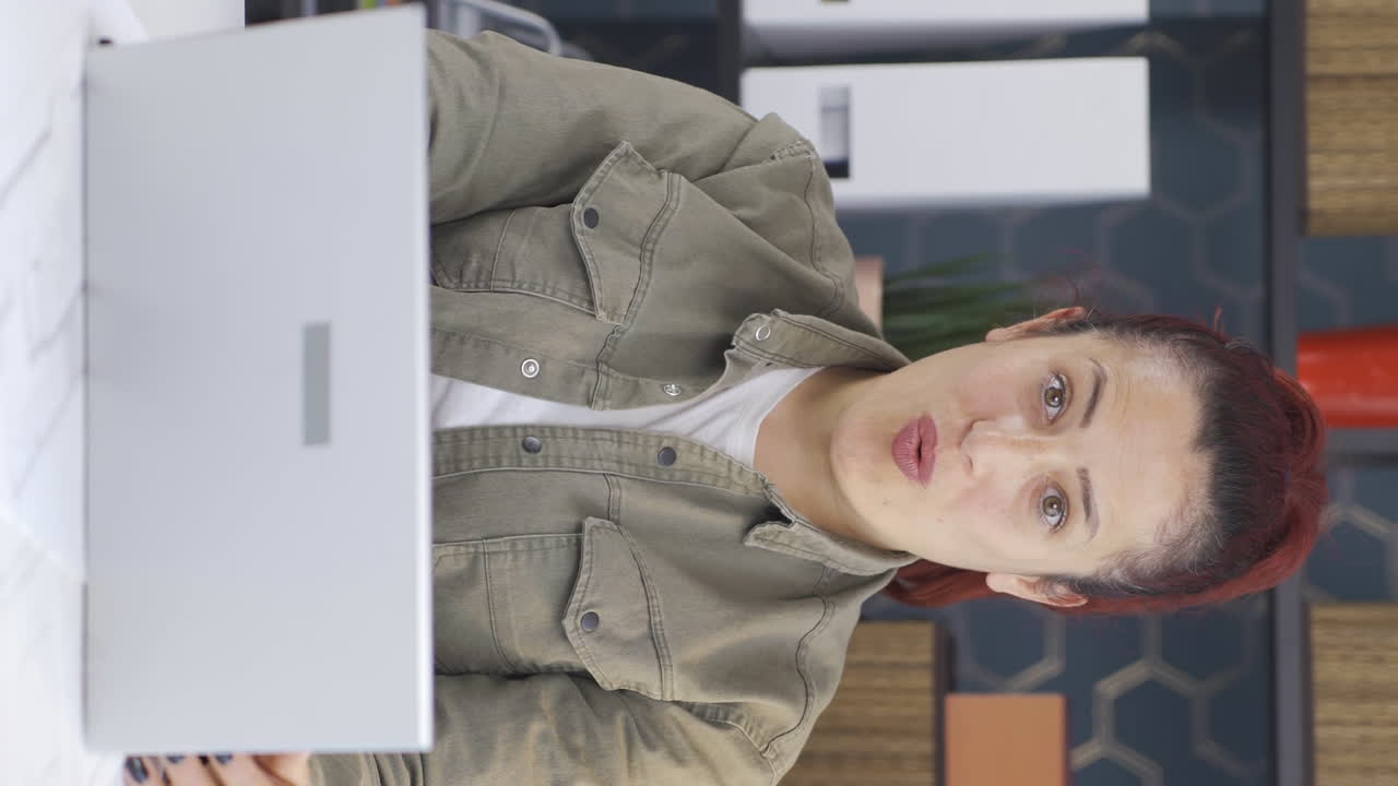 video vertical de una mujer de negocios mirando a la cámara con una expresión de asombro.