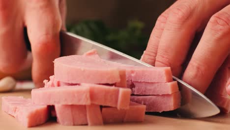 ham italian mordatella, man slices of traditional italian antipasti mortadella sausage on a wooden cutting board, close up macro of chicken or turkey jamon, fat breakfast dish.