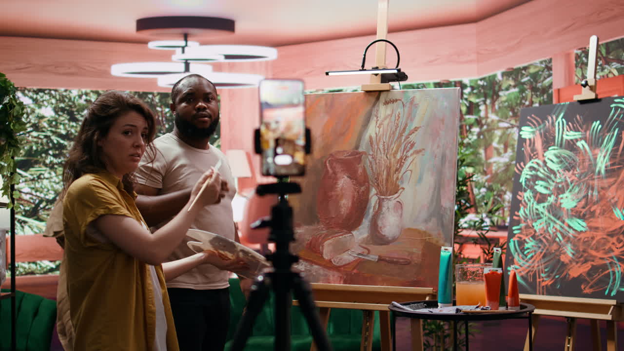 Artists painting still life and streaming live video