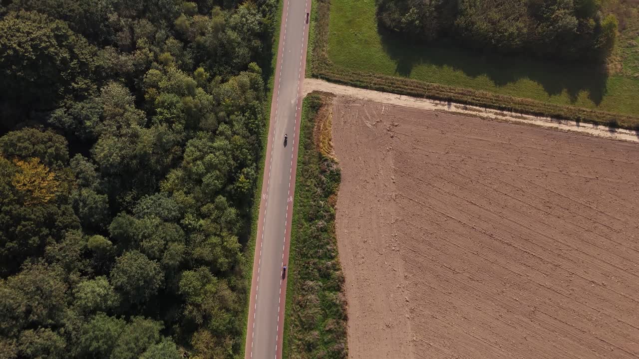 Aerial view of road, field and forest