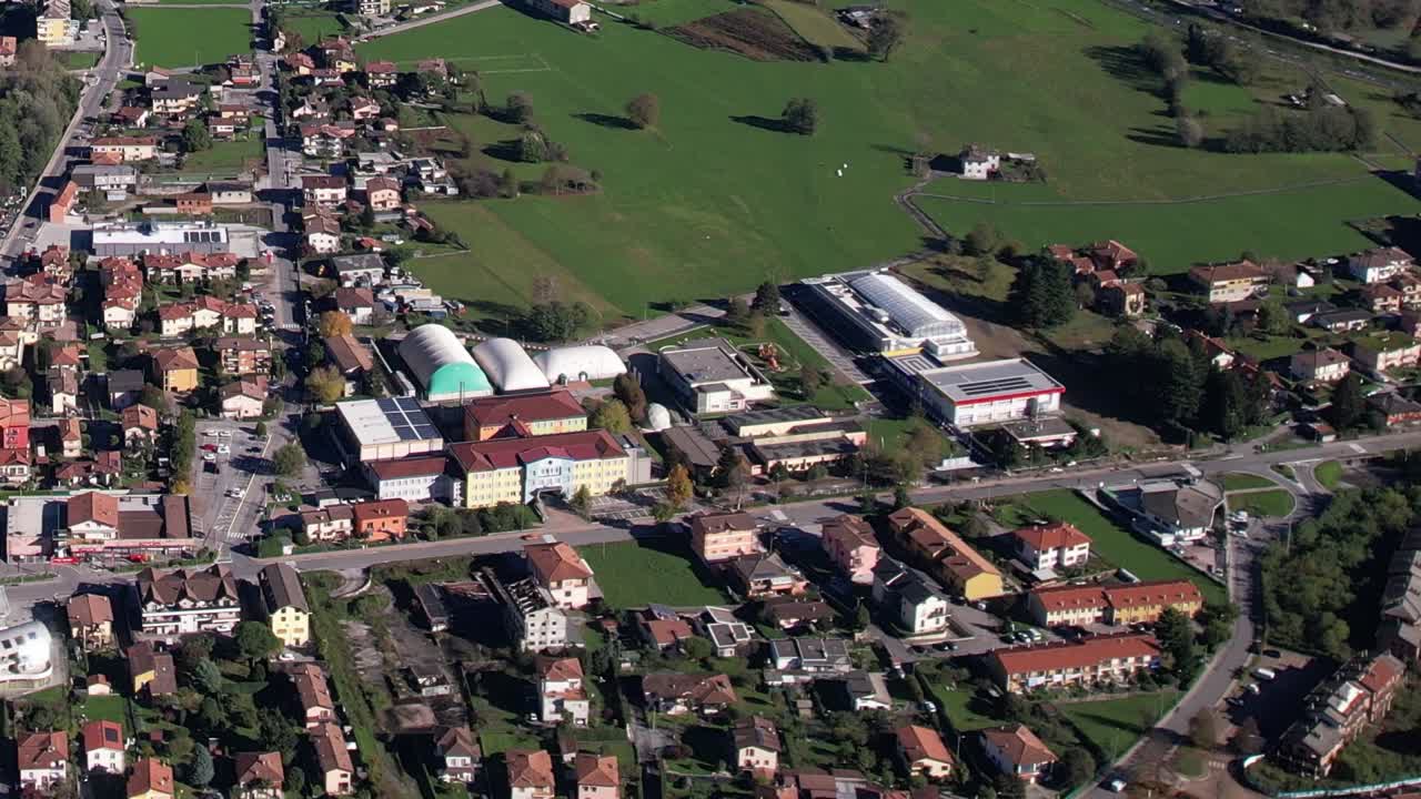 Stunning aerial view of Italian Alps and nearby town in autumn