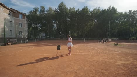female tennis player practicing serve on outdoor court