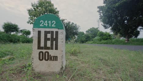 highway milestone showing distance of leh