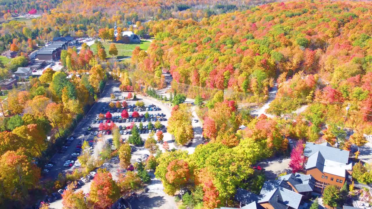 Aerial shot of small village in Estrie, Quebec, Canada during the fall. Colorful trees with views of autumn leaves changing