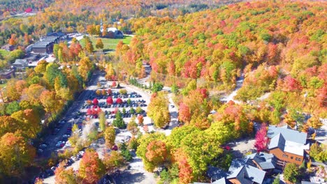 aerial shot of small village in estrie, quebec, canada during the fall. colorful trees with views of autumn leaves changing
