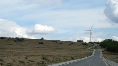 lapso de tiempo de una sola turbina eólica en un día soleado, primer plano de tierra seca