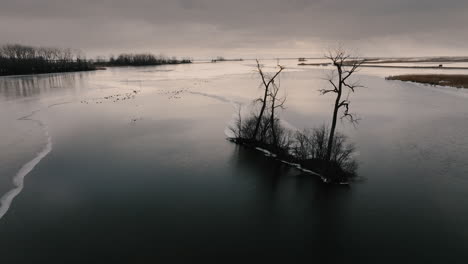 Drone-shot-of-frozen-lake-Eire-in-winter-at-sunrise