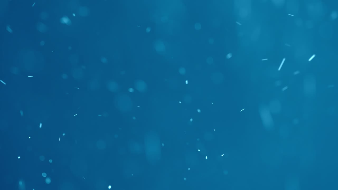 partículas arremolinadas blancas sobre un fondo azul