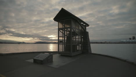 wide shot of a nine o clock gun in vancouver stanley park seawall, morning, cloudy, slowmotion