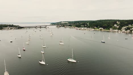 aerial expansive view of coastal town with sail boats and vessels over bay water in rhode island