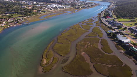 Stilbaai-salt-marsh-and-mud-flats-on-Goukou-estuary,-aerial-tilt-up-view