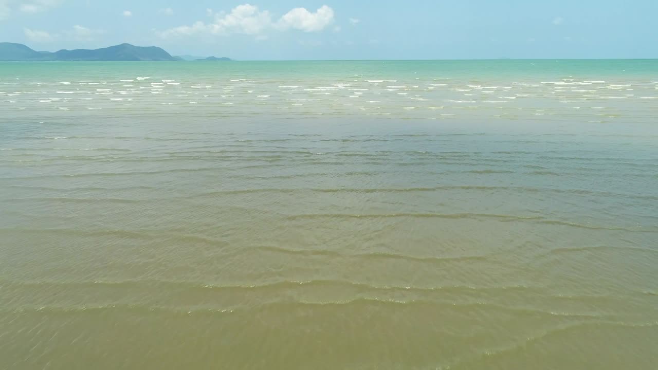 4K woman walk on the beach, foot print on sand texture and coconut tree on the beach photo by drone.