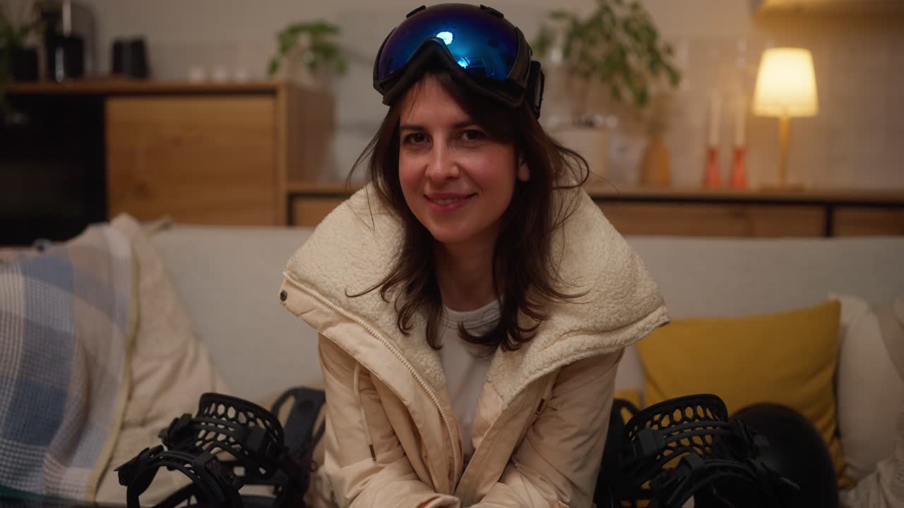Woman relaxing at home with her snowboarding gear