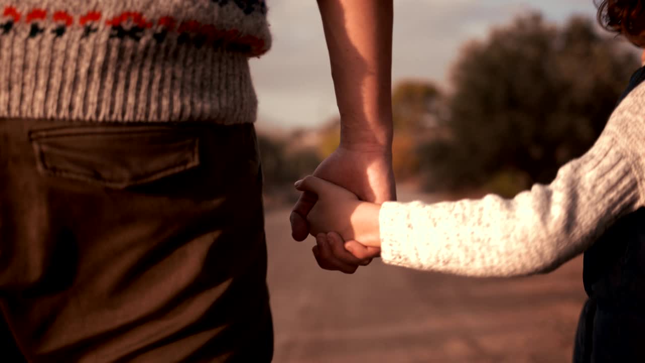 padre e hijo tomados de la mano y caminando con el perro