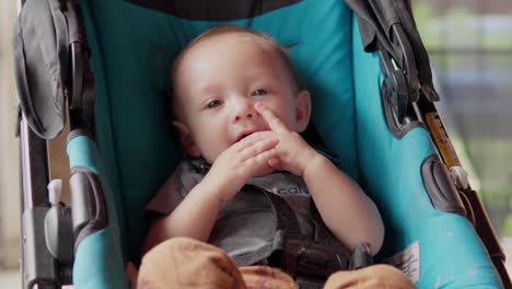 a baby sucking his hand and smiling