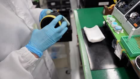 close-up of a worker checking the zoom operation of a lens