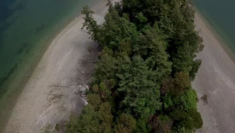 Aerial, rising, drone shot, tilting towards Dead Man's Island, partly sunny day, at Cutts State Park, in Washington, USA