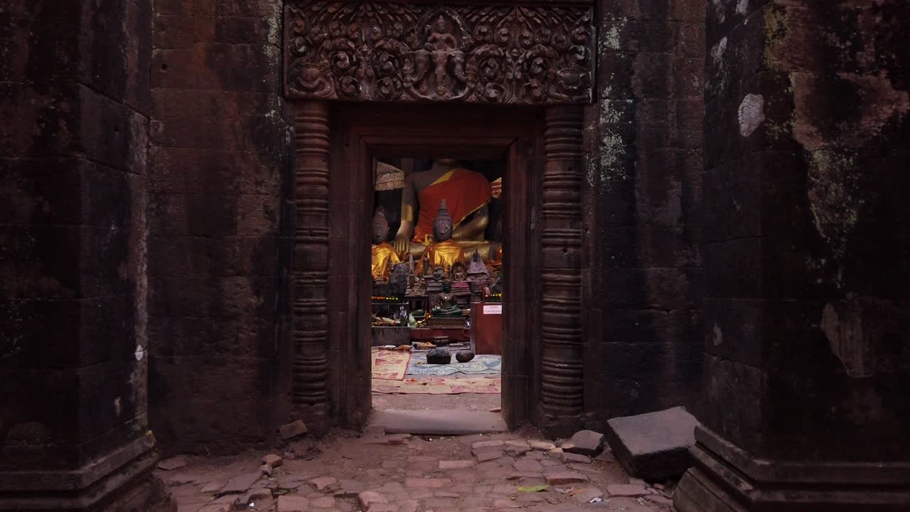 Champassak / Laos - Feb 13: Vat Phou – ruined Khmer Hindu Mountain Temple. Buddhist altar buddha statues. Holy place for prayer. Buddhism religion. UNESCO World Heritage. Ancient temple complex. Slow