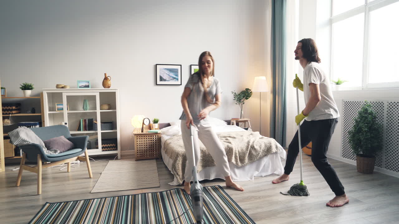 Couple Dancing While Cleaning the House