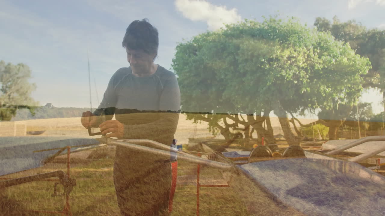 Assembling equipment outdoors, person working with animation over scenic landscape