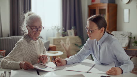 elderly woman consulting with financial advisor at home