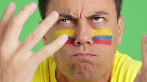 man with colombian national flag upset with a referee
