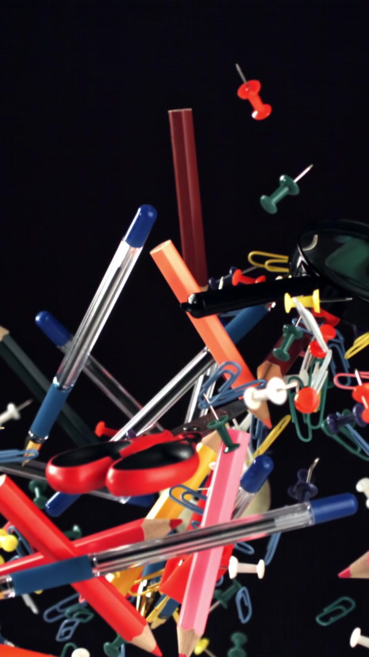 Colorful Stationery and Office Supplies Floating in Slow Motion