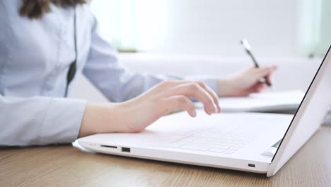 close up image female hands typing on laptop keyboard