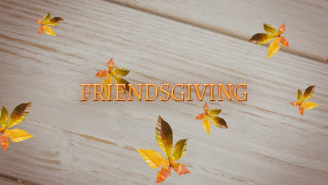 Animation of friendsgiving text over autumn leaves on wooden background