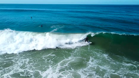 surfer catches clean wave at oceanside pier