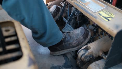 Man's-foot-controlling-a-forklift